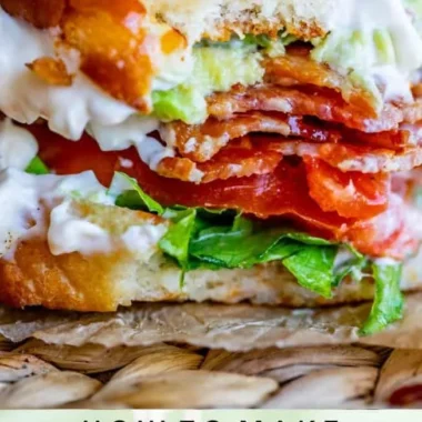 Avocado Bacon Sandwich with lettuce and tomato on a plate