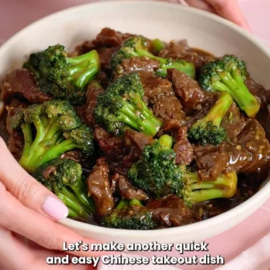 Beef and broccoli stir-fry served in a bowl with chopsticks.