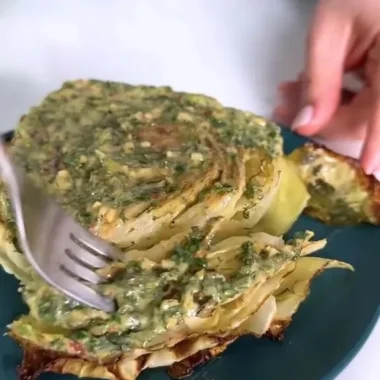 Cabbage steaks topped with herb butter served on a plate