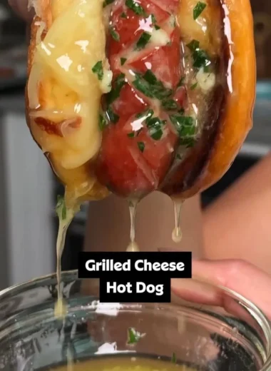 Garlic butter grilled cheese hot dogs served on a plate with melted cheese