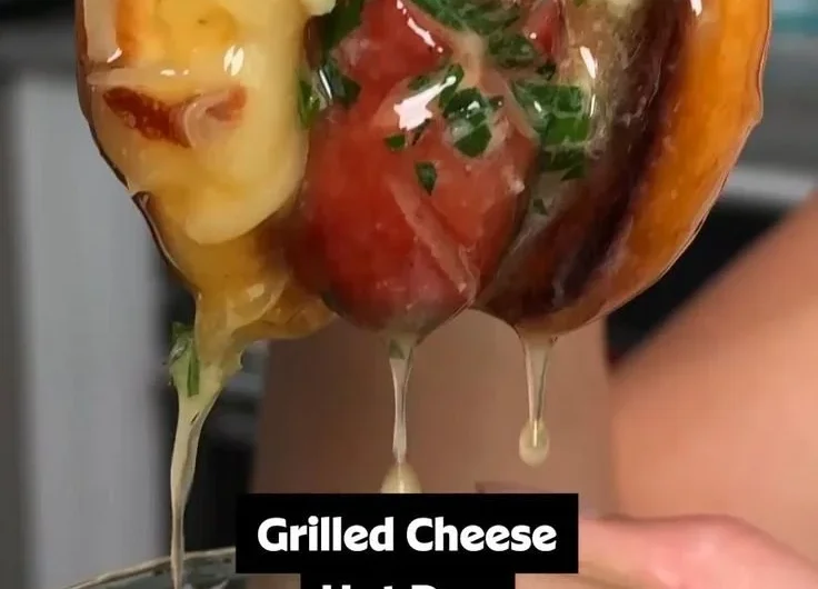 Garlic butter grilled cheese hot dogs served on a plate with melted cheese