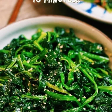 Korean Spinach Salad (Sigeumchi Namul) served in a bowl, garnished with sesame seeds.