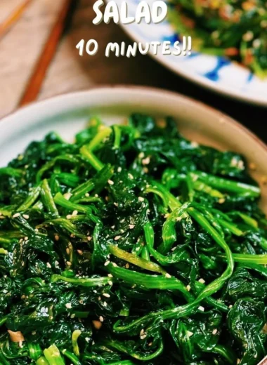 Korean Spinach Salad (Sigeumchi Namul) served in a bowl, garnished with sesame seeds.