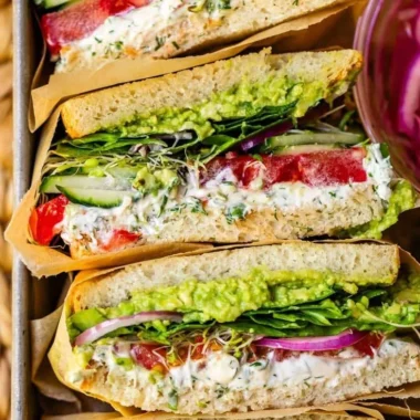 A colorful and delicious fresh veggie sandwich with assorted vegetables and bread