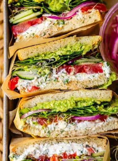 A colorful and delicious fresh veggie sandwich with assorted vegetables and bread