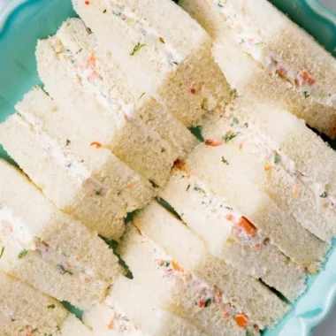 Veggie cream cheese finger sandwiches on a platter, ideal for parties