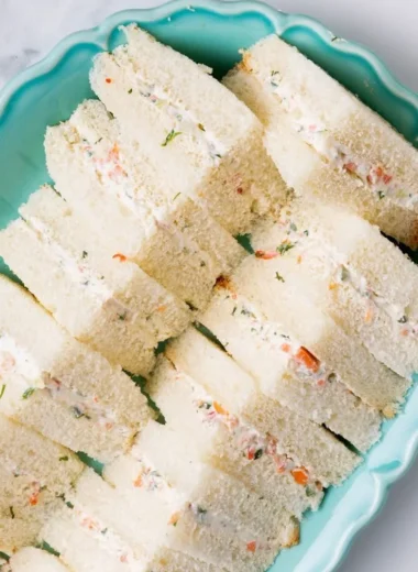 Veggie cream cheese finger sandwiches on a platter, ideal for parties