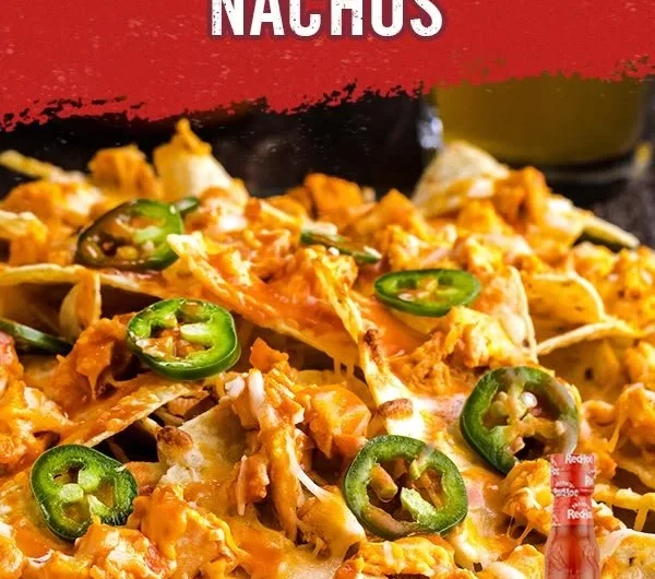 Delicious Buffalo Chicken Nachos topped with cheese and fresh ingredients for a spicy delight.