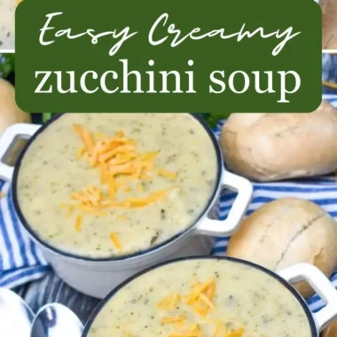 A bowl of creamy zucchini soup garnished with herbs and served with bread.