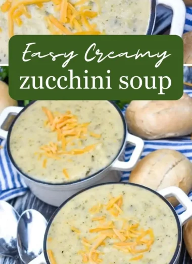 A bowl of creamy zucchini soup garnished with herbs and served with bread.