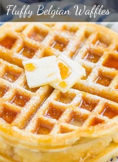 Fluffy Belgian waffles served with syrup and fresh berries