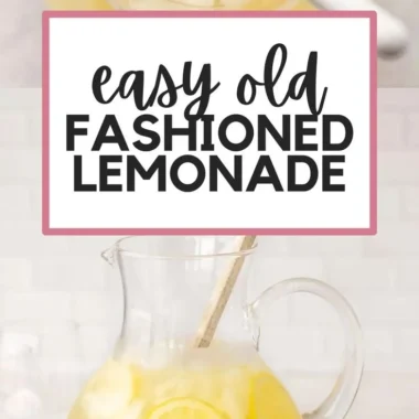 Pitcher of homemade lemonade with sliced lemons and ice cubes