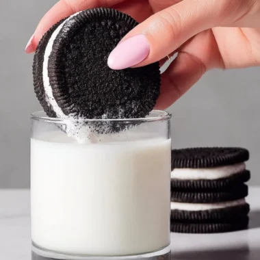 Homemade Oreo cookies on a plate with a glass of milk