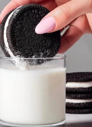 Homemade Oreo cookies on a plate with a glass of milk
