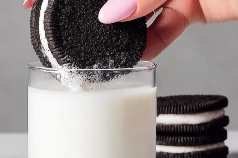Homemade Oreo cookies on a plate with a glass of milk