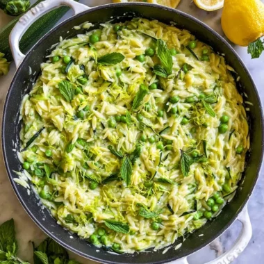 Lemon Orzo with Zucchini served in a bowl, garnished with fresh herbs.