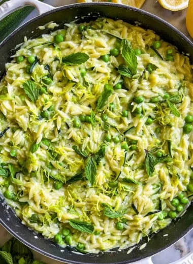 Lemon Orzo with Zucchini served in a bowl, garnished with fresh herbs.