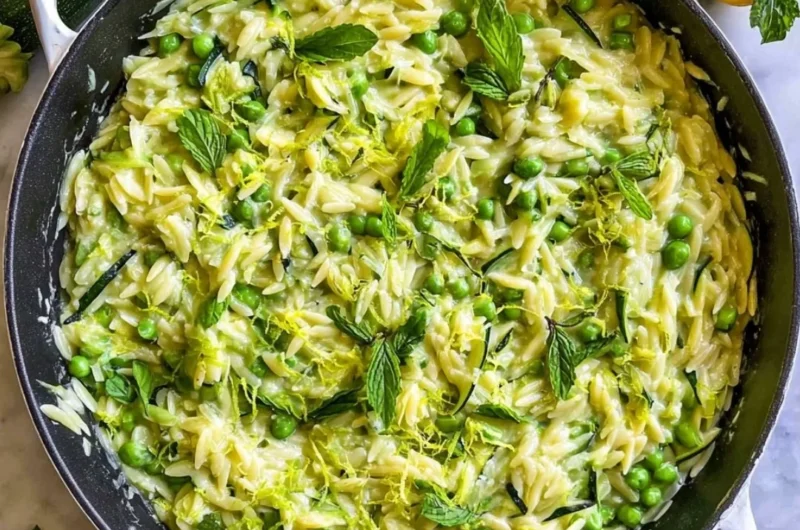 Lemon Orzo with Zucchini served in a bowl, garnished with fresh herbs.
