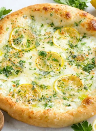 Delicious Lemon Pizza topped with fresh ingredients and citrus zest.