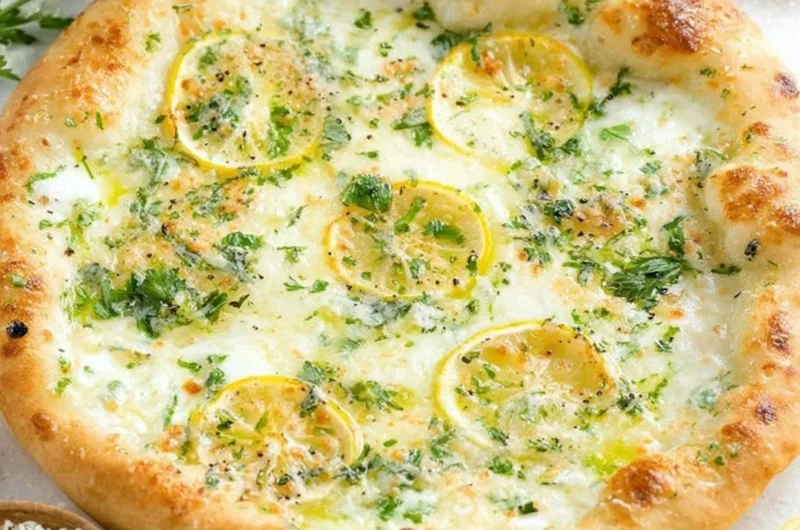 Delicious Lemon Pizza topped with fresh ingredients and citrus zest.