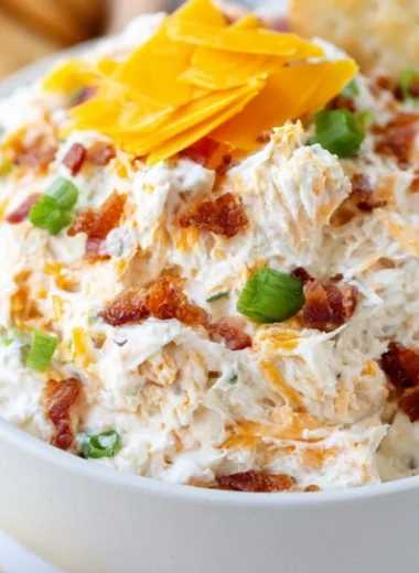 Delicious Million Dollar Crack Dip served in a bowl with crackers and veggies.