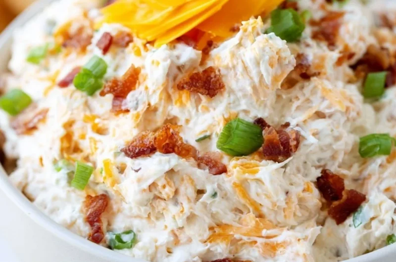 Delicious Million Dollar Crack Dip served in a bowl with crackers and veggies.