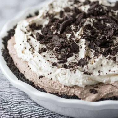 Delicious Oreo Pudding Pie garnished with crushed Oreos and whipped cream