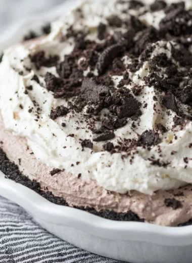 Delicious Oreo Pudding Pie garnished with crushed Oreos and whipped cream