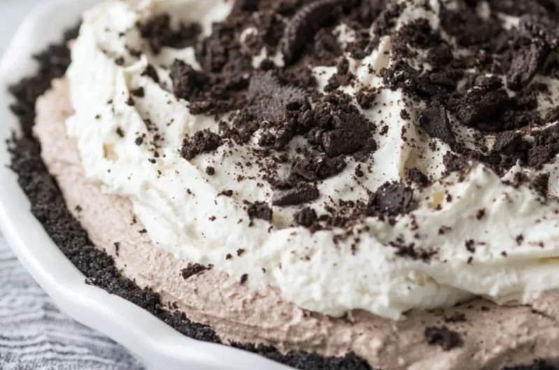 Delicious Oreo Pudding Pie garnished with crushed Oreos and whipped cream