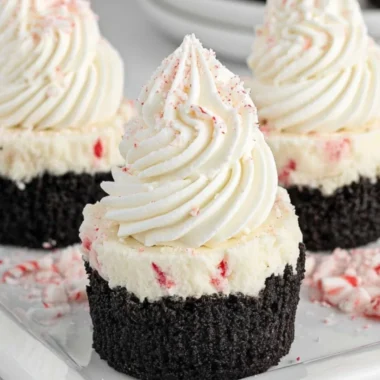 Mini no-bake peppermint cheesecakes topped with crushed candy canes.