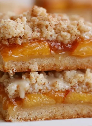 Delicious summery peach bars topped with a golden crust