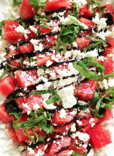 Colorful watermelon salad topped with herbs and feta cheese