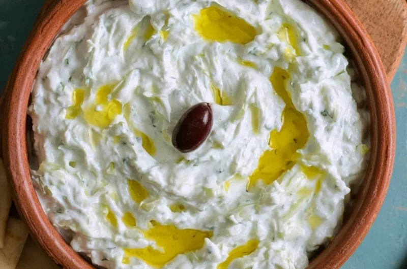 A delicious bowl of Greek tzatziki with fresh cucumbers and herbs