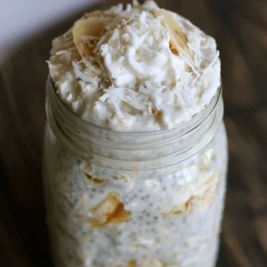 Delicious bowl of banana and coconut overnight oats topped with fresh fruit