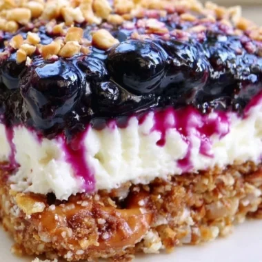 Delicious Blueberry Pretzel Salad with a creamy layer and crunchy pretzel crust