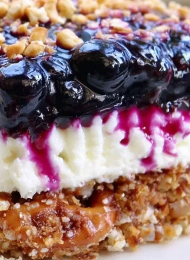 Delicious Blueberry Pretzel Salad with a creamy layer and crunchy pretzel crust