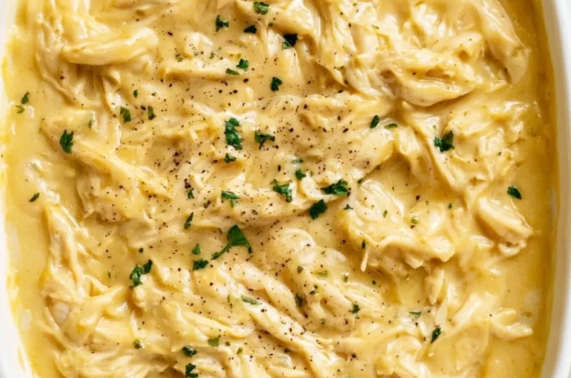 Plate of tender chicken topped with savory gravy, served with mashed potatoes.