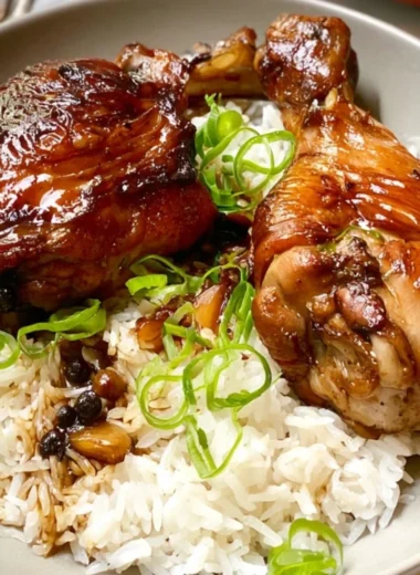 Cozy chicken adobo served in a bowl with rice and herbs