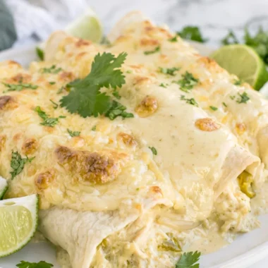 Cozy creamy white chicken enchiladas topped with cheese and fresh cilantro