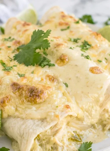 Cozy creamy white chicken enchiladas topped with cheese and fresh cilantro