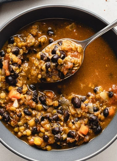 Cozy bowl of protein-packed black bean lentil soup topped with fresh herbs