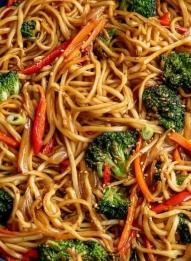 Bowl of cozy vegetable lo mein with colorful vegetables and noodles