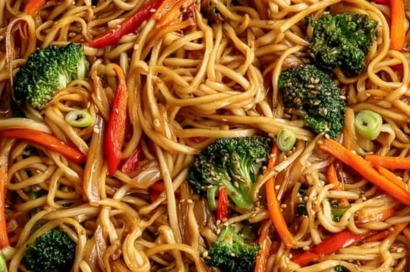 Bowl of cozy vegetable lo mein with colorful vegetables and noodles