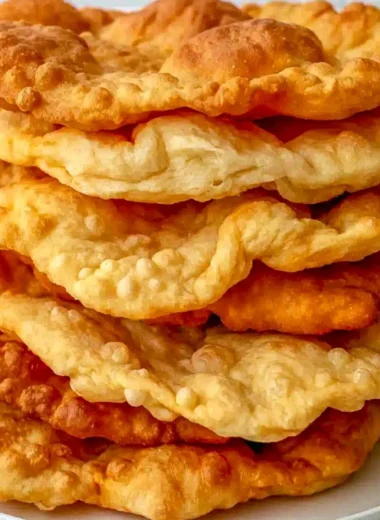 Plate of freshly made Native American Fry Bread topped with honey and powdered sugar