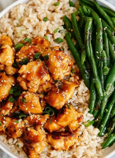 Plate of Honey Garlic Chicken served with green beans for a nutritious meal.