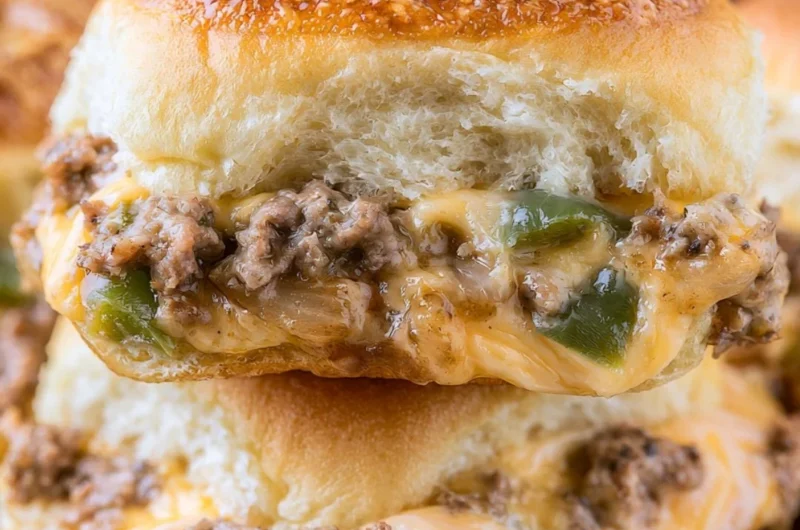 Delicious Philly cheesesteak sliders served on a platter with toppings.