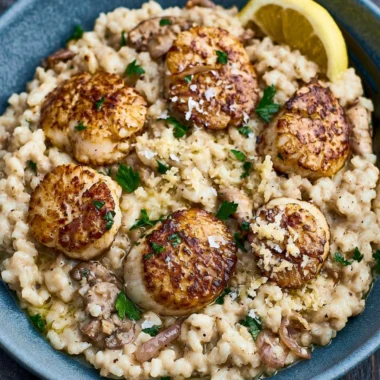 Delicious scallops served on creamy risotto in a gourmet dish