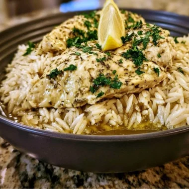 Slow Cooker Lemon Herb Chicken served with rice and herbs