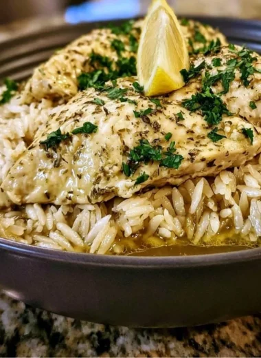 Slow Cooker Lemon Herb Chicken served with rice and herbs