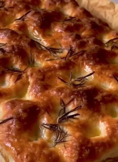 Freshly baked sourdough focaccia with herbs and olive oil